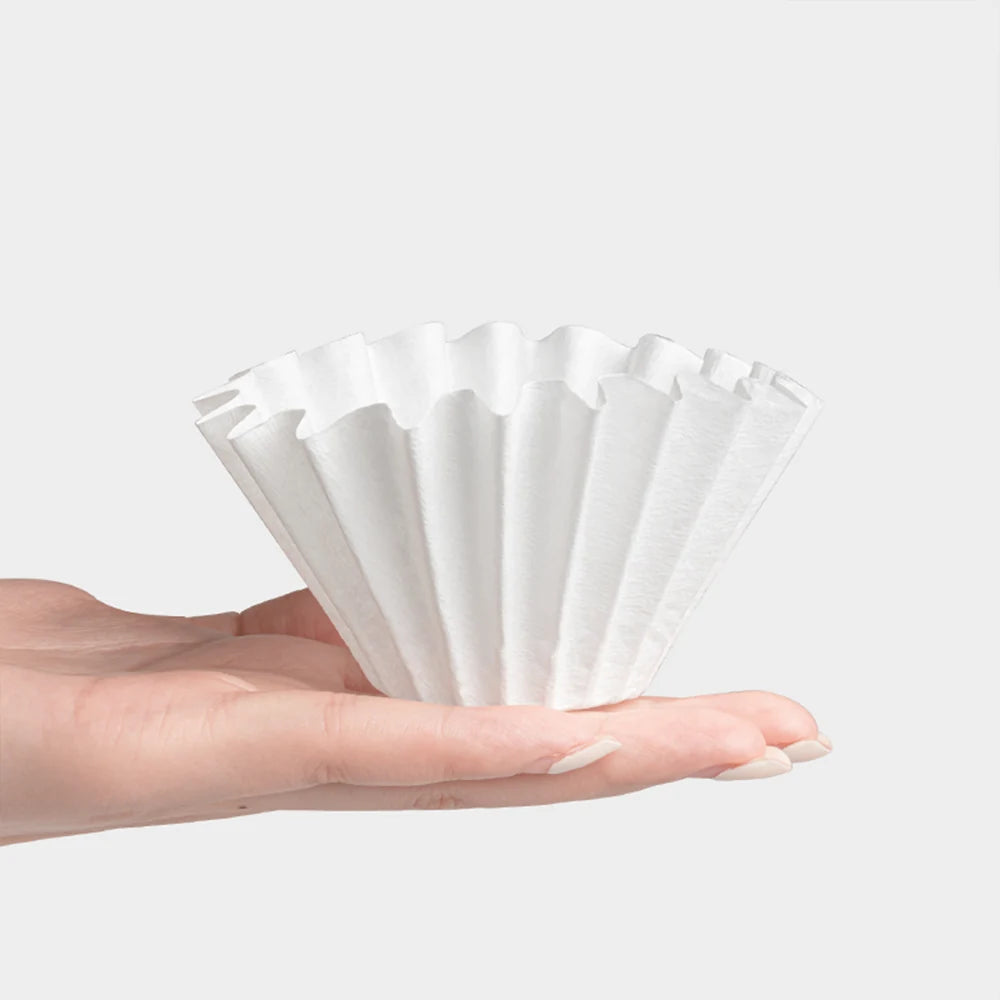 A human hand holding one piece of filter in palm