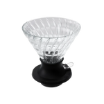 Clear plastic coffee dripper with black base on a white background
