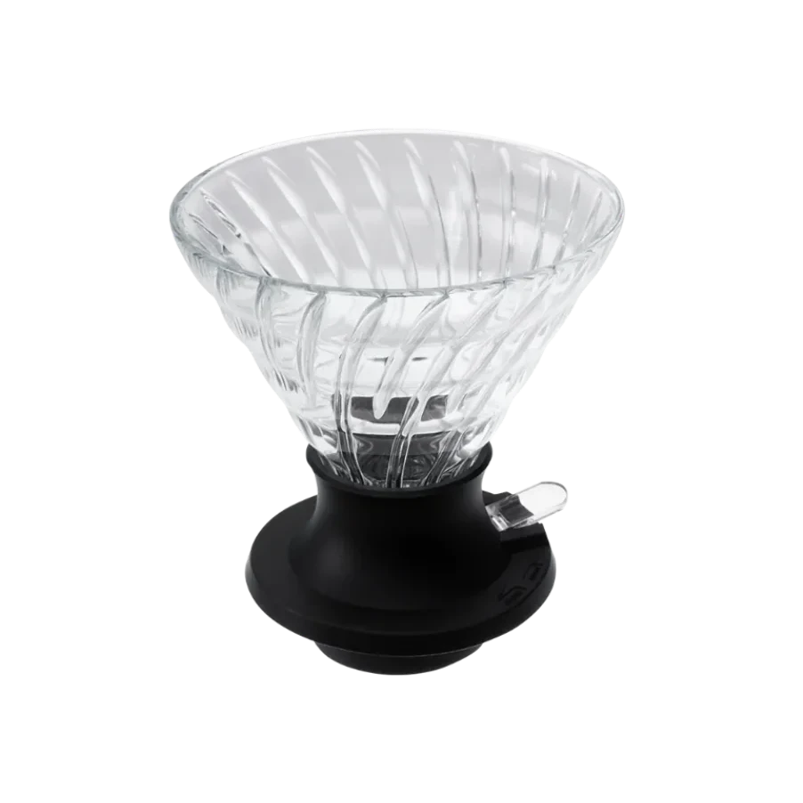 Clear plastic coffee dripper with black base on a white background