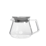 Clear glass server with a silver lid on a white background