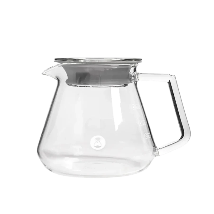 Clear glass server with metal lid on a white background